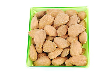 Image showing Bunch of almond nuts on a green cup