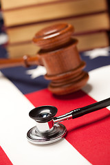 Image showing Gavel, Stethoscope and Books on Flag