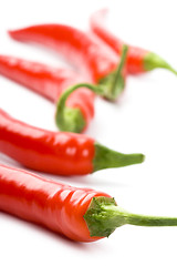 Image showing five red chili peppers