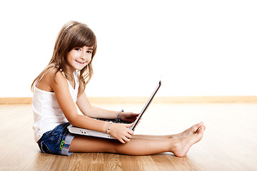 Image showing Child playing with a laptop