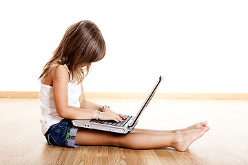 Image showing Child playing with a laptop