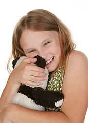 Image showing girl hugging her teddy bear