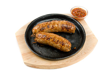 Image showing sausages at pan with sauce