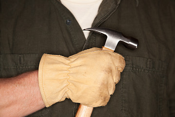 Image showing Man with Leather Construction Glove Holding Hammer