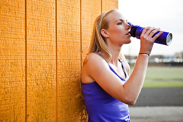 Image showing Sporty woman drinking