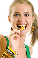 Image showing blond woman licking candy