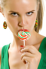 Image showing Glamorous young woman licking lollypop
