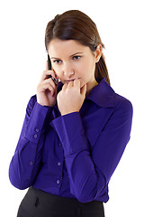 Image showing A businesswoman worries over the phone