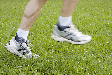 Image showing Running feet in green grass