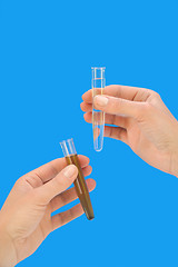 Image showing Clean and dirty water samples in hands