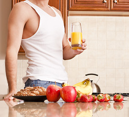 Image showing Young Man Holding Glass of Orange Juice