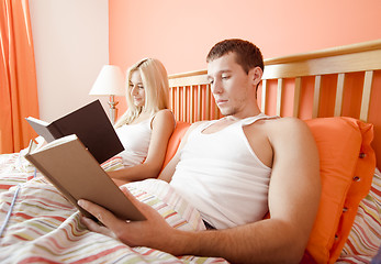 Image showing Couple Reading in Bed