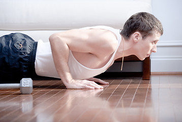 Image showing Man Doing Push-ups in Living Room