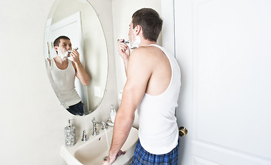 Image showing Young Man in Bathroom Shaving