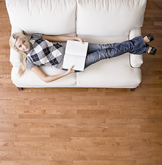 Image showing Overhead View of Woman With Book on Couch