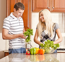 Image showing Young Couple Making Salad