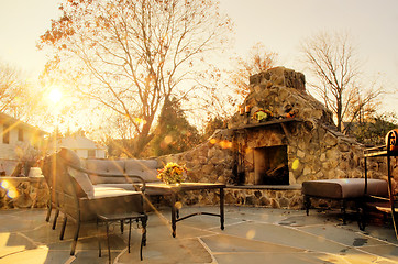 Image showing Sunlit Patio With Stone Fireplace