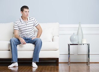 Image showing Man Sitting on Living Room Couch