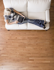 Image showing Overhead View of Woman on Couch With Laptop