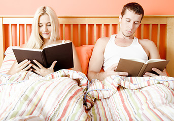 Image showing Couple Reading in Bed