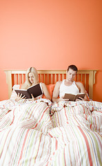 Image showing Couple Reading in Bed