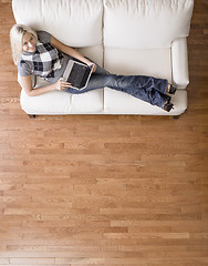 Image showing Overhead View of Woman on Couch With Laptop