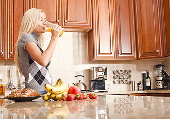 Image showing Young Woman Drinking Glass of Orange Juice