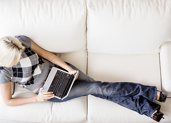 Image showing Overhead View of Woman on Couch With Laptop