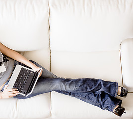 Image showing Overhead View of Woman on Couch With Laptop