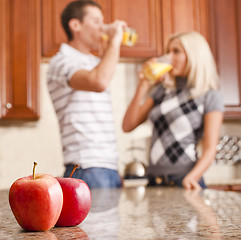 Image showing Young Couple Drinking Glass of Orange Juice