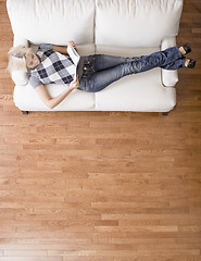 Image showing Overhead View of Woman Reading on Couch