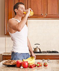 Image showing Young Man Drinking Orange Juice