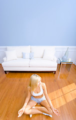 Image showing Young Woman Sitting on Wood Floor Meditating