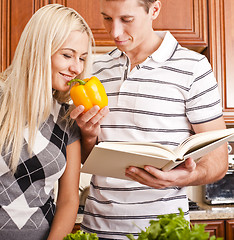 Image showing Young Woman Smelling Pepper Held by Young Man