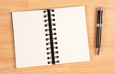 Image showing Blank Spiral Note Pad and Pen on Wood