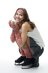 Image showing Woman in ice skates sit with cup of coffee