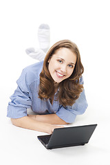 Image showing Happy woman lay on the floor with laptop