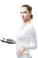 Image showing Confused woman with calculator