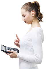 Image showing Clever woman with calculator thinking