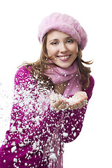 Image showing Woman blow snowflakes from hands