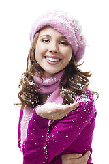 Image showing Woman blow snowflakes from palm