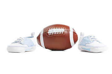 Image showing Football with baby shoes