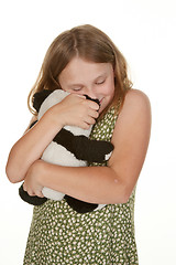 Image showing girl hugging her teddy bear