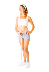 Image showing Young Woman Measuring Herself On White