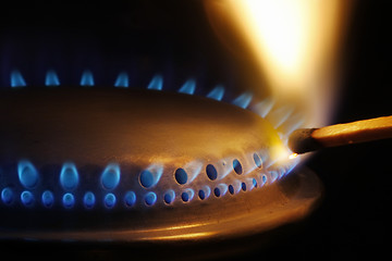 Image showing Match lightening a gas stove