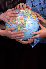 Image showing Hands On A Globe