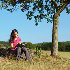 Image showing Girl Writing in Note Book