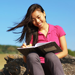 Image showing Girl Writing in Note Book