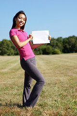 Image showing Girl with blank sign in field