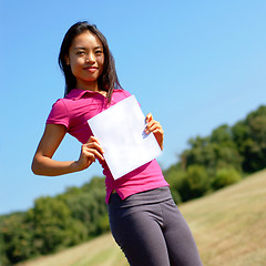 Image showing Girl with blank sign in field